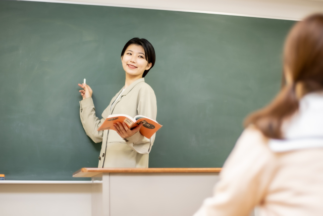 黒板で授業をする女教師